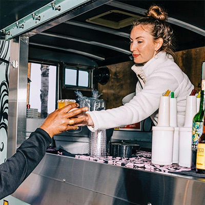 Bartender serving margaritas